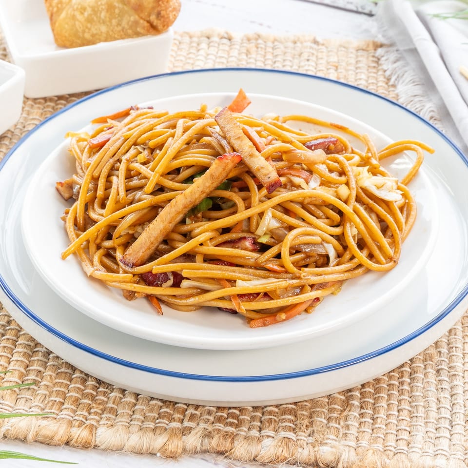 Red Panda Wok & Grill's Chinese lo mein noodles with vegetables and meat on a white plate.