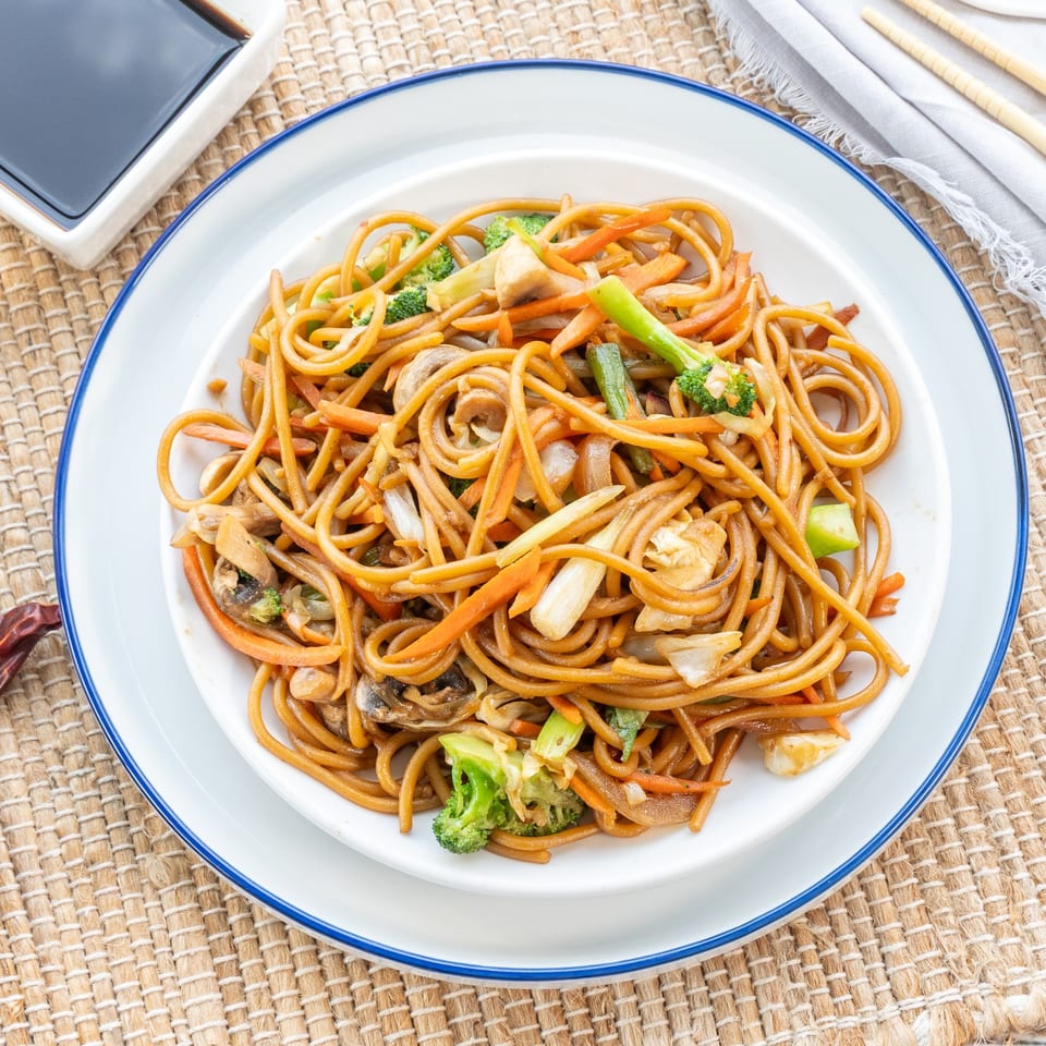A plate of Red Panda Wok & Grill's vegetable lo mein with broccoli, carrots, and mushrooms.