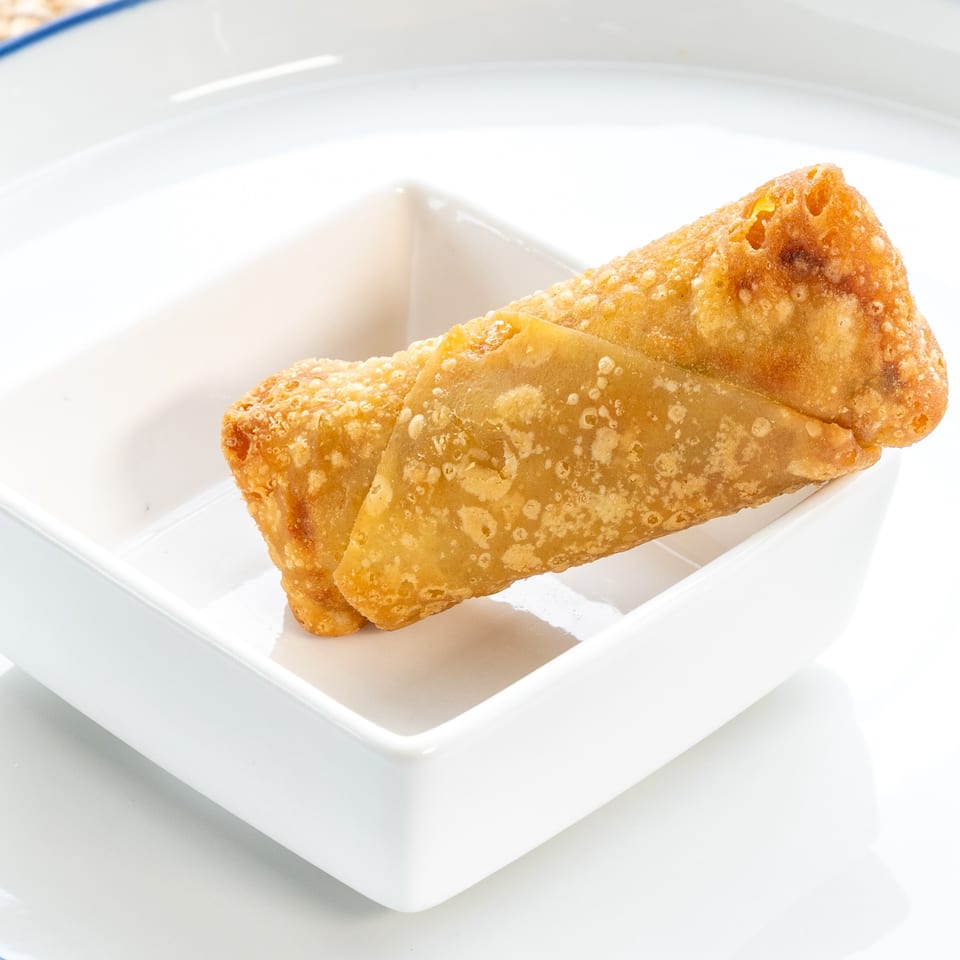 Two crispy golden-brown egg rolls from Red Panda Wok & Grill, served in a white rectangular dish.